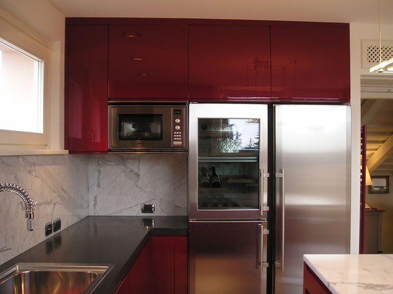 Glossy lacquered kitchen with island and marble top