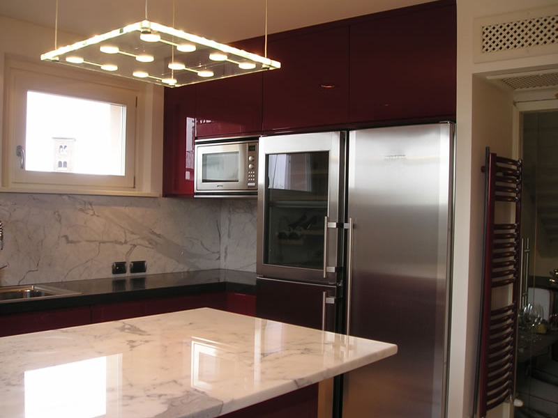 Glossy lacquered kitchen with island and marble top