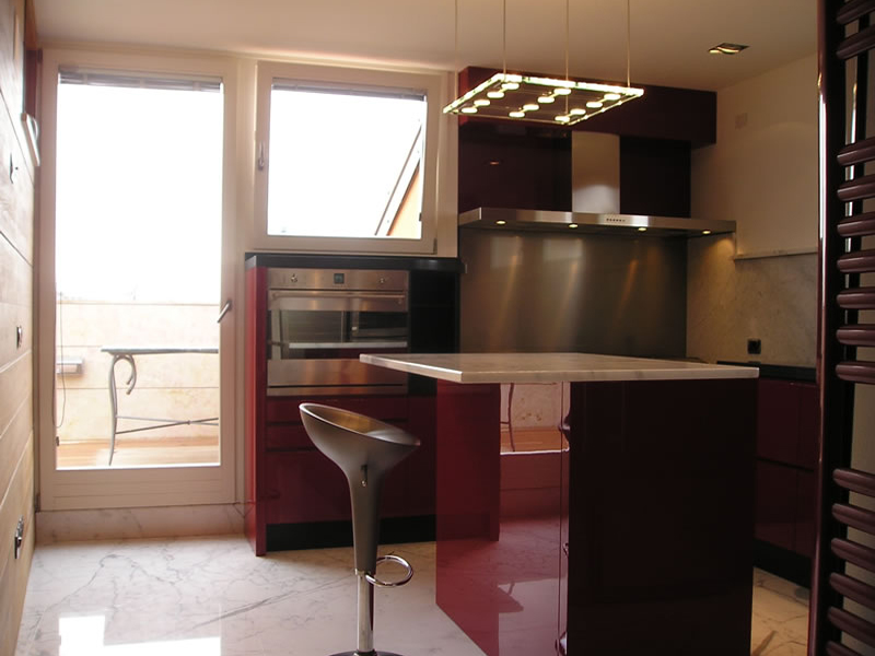 Glossy lacquered kitchen with island and marble top